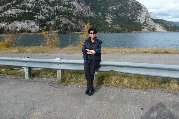 Dr. M. Anne Naeth against a guardrail near Exshaw limestone quarry reclamation site