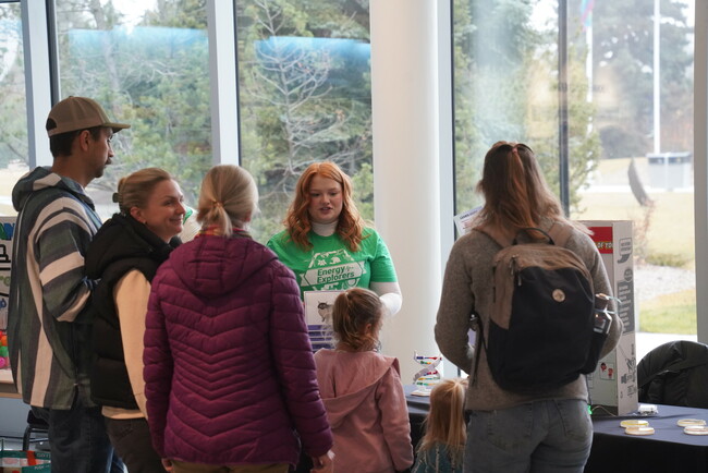 Nina Deschner explains DNA to two children and four adults.